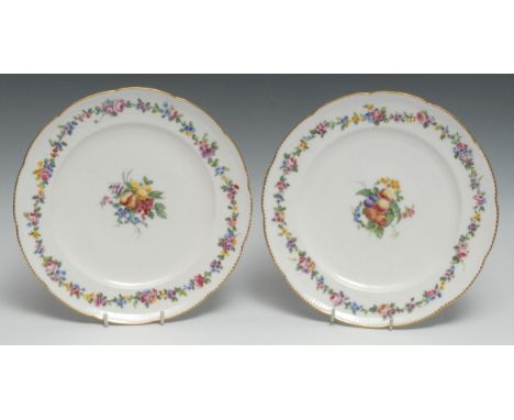 A pair of Sèvres shaped circular plates,lwith feuille de choux moulding at the rims, painted by Le Bel with a central colourf