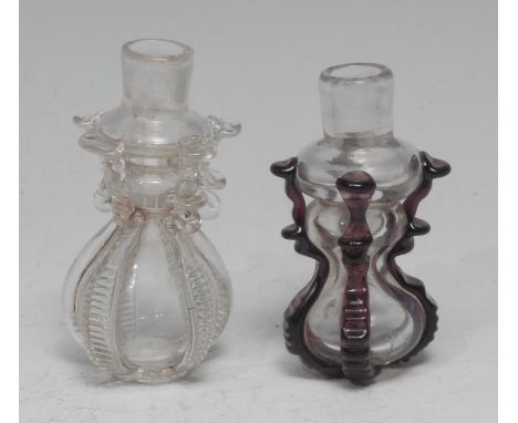 A small 18th century cruciform glass flask or phial, hourglass reservoir applied with purple lugs, 6cm long; another, clear g