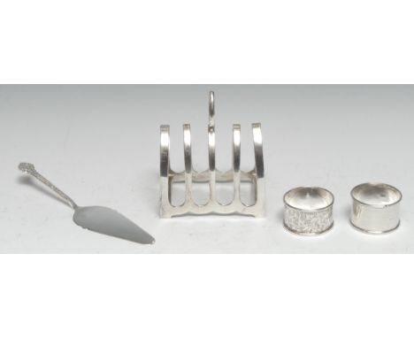 A George V silver five bar toast rack, axehead handle, pointed arched divisions, 9.5cm long, E Viner, Sheffield 1931; an Arts