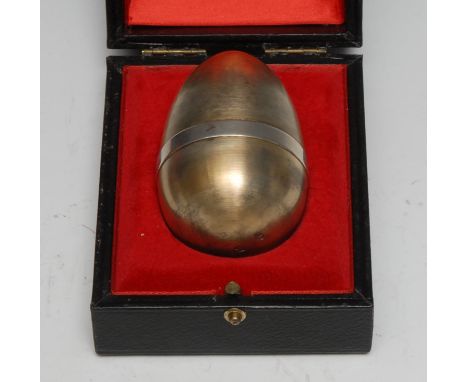 Stuart Devlin (1931 - 2018) - an Elizabeth II silver-gilt and silver surprise egg, enclosing a leprechaun on a toadstool, no.