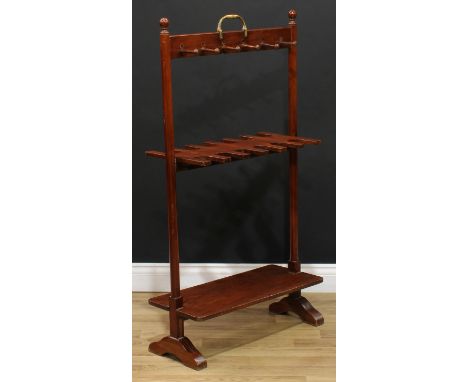 A 19th century mahogany double-sided whip and boot stand, brass carry handle above an arrangement of riding crop or walking s