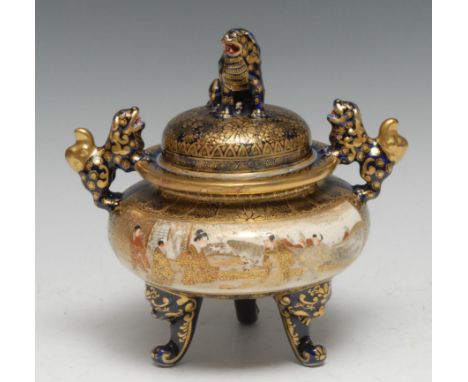 A Japanese Satsuma tripod twin-handle koro, well-painted with traditional figures of the shogunate in typical iron red and gi