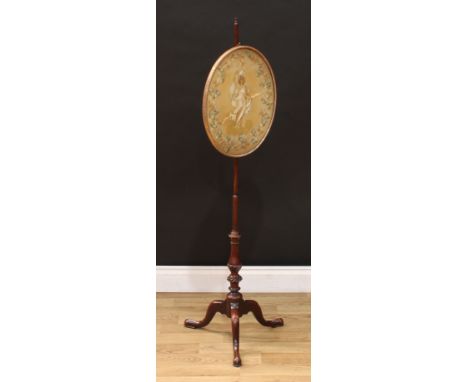 A George III mahogany tripod pole screen, the oval banner with a silk picture, depicting a maenad with flowing dress and ribb