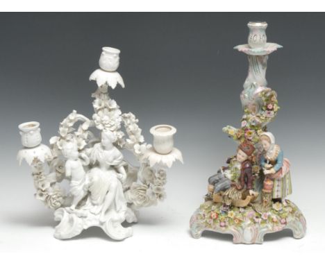 A German Rococo Revival Blanc de Chine three-branch figural candelabrum, Diana and Cupid, before a flowering superstructure, 