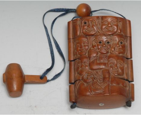 A Japanese four-section boxwood rounded rectangular inro, carved in bold relief with comical faces and animals, hammer netsuk