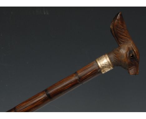 An early 20th century novelty walking stick, the softwood handle carved as the head of a hare, gilt metal ferrule, palmwood c
