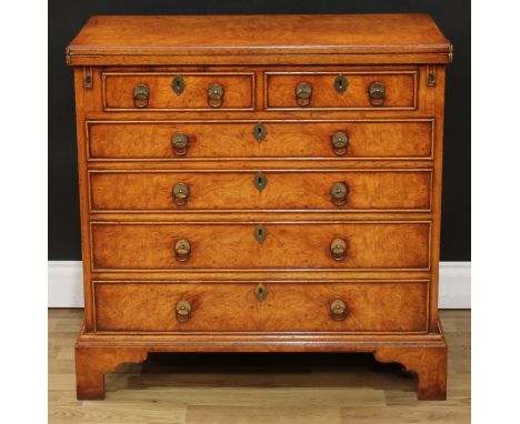 A Queen Anne/George I style walnut bachelor's chest, hinged fold-over rectangular top above two short and four long graduated