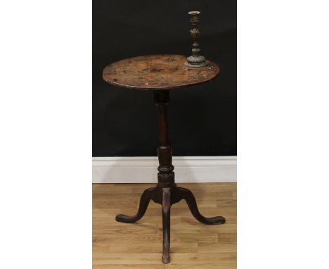 A mid-18th century oak tripod occasional table, near-circular top with incised wavy border, turned column, cabriole legs, pad