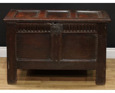 A Charles II oak blanket chest, of small proportions, hinged three panel top above a nulled frieze and two further panels, st