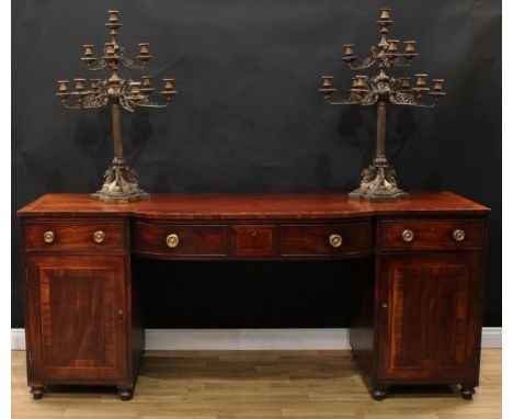 A Regency mahogany bow-centre sideboard, crossbanded top above a central frieze drawer, each pedestal with a further short co