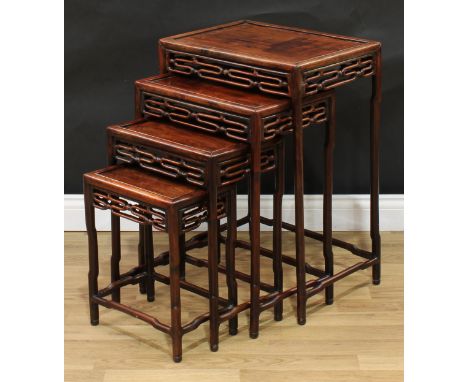 A set of Chinese hardwood quartetto tables, each with a rectangular panel top, shaped aprons, ruyi shaped legs and stretchers