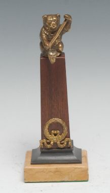 A novelty pocket watch stand, composed as a bear crested an Empire design gilt-metal mounted mahogany obelisk, Sienna-type ma