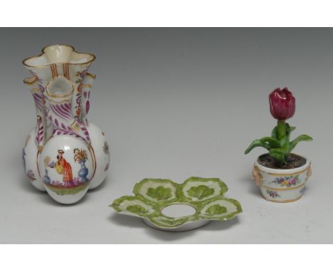 A Meissen botanical model, of a tulip, painted in naturalistic tones, in a banded jardinière, twin mask handles, 9cm high, un