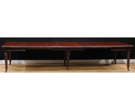 A late Victorian mahogany six-leg extending dining table, rounded rectangular top with five additional leaves, the outer legs