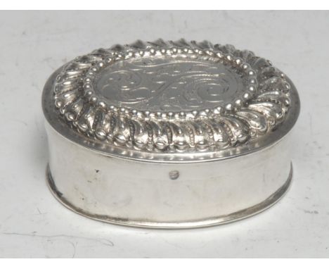 An early 18th century German silver oval spice or snuff box push-fitting cover chased with scrolling acanthus within a fluted