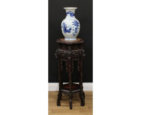 A 19th century Chinese hardwood vase or jardiniere stand, shaped circular top with inset soapstone panel, the pagoda frieze p