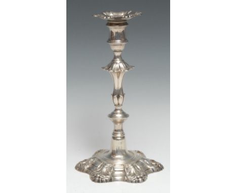 A George II cast silver table candlestick, of seamed construction, detachable nozzle, knopped stem, shaped circular shell bas