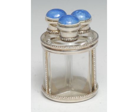 A George V silver and enamel three-section scent bottle stand, each triform perfume flask with engine turned cover decorated 