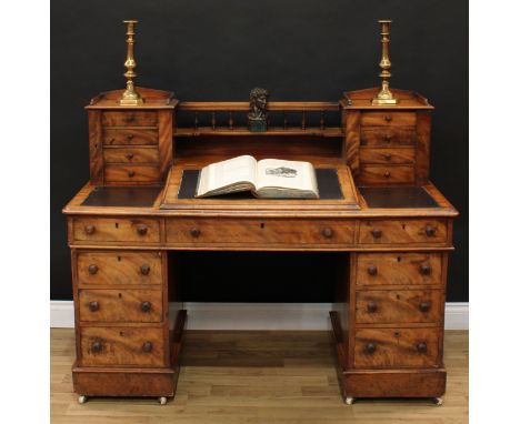 A Victorian walnut twin pedestal writing desk, the superstructure with spindle gallery flanked by two flights of small drawer