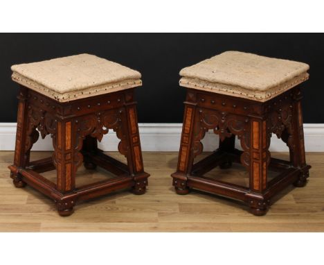 A pair of Reformed Gothic mahogany and pollard oak stools, in the manner of Augustus Welby Northmore Pugin, each with square 