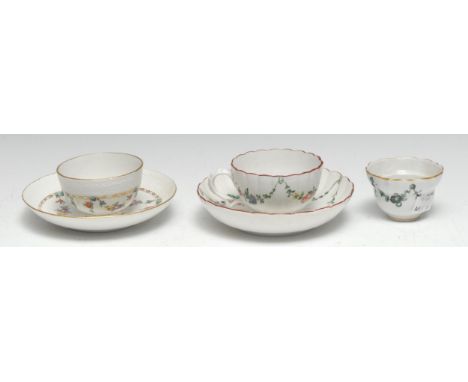 A Bristol fluted teacup and saucer, enamelled with polychrome swags suspended from hoops, painted X in blue enamel, c1775;  a