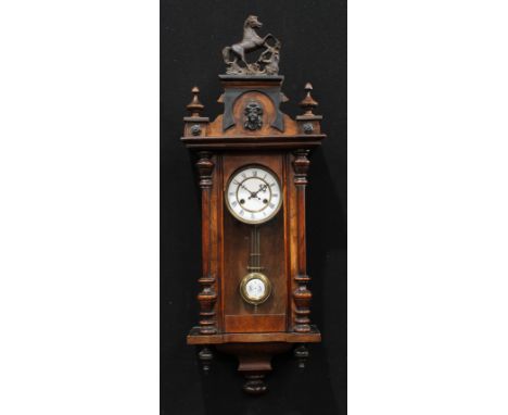 A 19th century walnut Vienna wall clock, 12.5cm enamel dial inscribed with Roman numerals, twin winding holes, the case with 