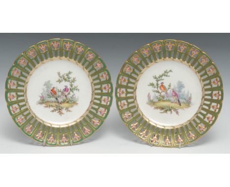 A pair of English Porcelain shaped circular plates, possibly by Copeland Spode, painted with fanciful birds within a pierced 