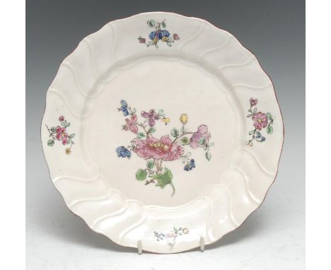 A rare French experimental hard paste porcelain plate, probably Brancas-Lauraguais, painted in the famille rose taste with sc