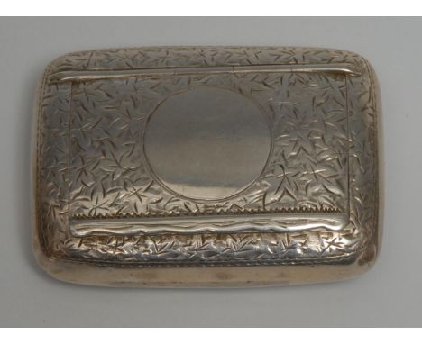A late Victorian/Edwardian silver rounded rectangular snuff box, engraved with scrolling foliage, hinged cover centred by a v