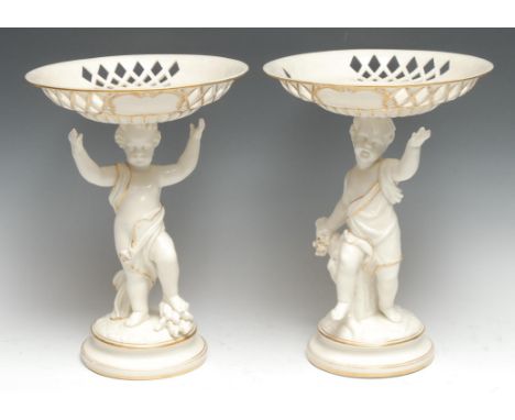 A pair of English porcelain figural comports, possibly Kerr &amp; Bins Worcester, each modelled as a putti emblematic of the 