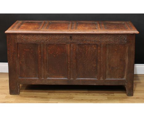 An 18th century oak blanket chest, hinged four panel top above a foliate blind fretwork frieze, re-lined interior, four panel