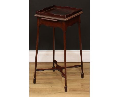 A 19th century mahogany kettle stand, wavy gallery above a slide, shaped apron, X-stretcher, outswept tapered square legs, sp