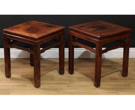 A pair of Chinese hardwood floor-vase stands, panel tops, shaped friezes, square section legs carved with scrolls, 51cm high,