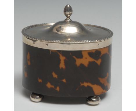 An Edwardian silver mounted tortoiseshell oval tea caddy, hinged cover with fluted knop finial, gadrooned borderm bun feet, 1