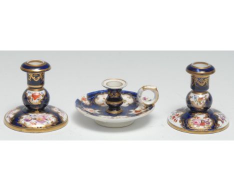 A pair of 19th century  Spode  small candlesticks, painted with flowers in gilt cartouches on a cobalt blue ground, mark in r