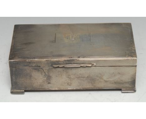 An Art Deco silver rectangular cigarette box, engine-turned, hinged cover, geometric bracket feet, cedar lined, 17.5cm wide, 