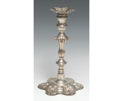 A George III cast silver table candlestick, of seamed construction, detachable nozzle, knopped stem, shaped circular shell ba