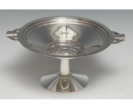 An Art Deco silver pedestal tazza, the field in relief with a dog, pierced geometric lug handles, 20.5cm wide, William Hutton