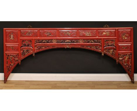 A Chinese parcel-gilt and cinnabar coloured hardwood architectural panel, possibly from an opium or wedding bed, pierced and 