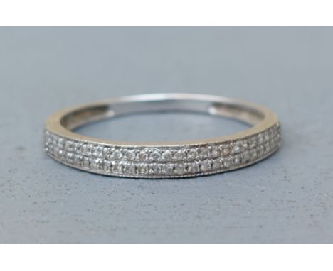 A modern twin row diamond half eternity ring in white metal to match previous lot.  Finger size R.