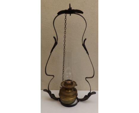 A wrought iron &amp; brass hanging oil lamp,  28" overall.