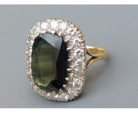 A certified natural sapphire &amp; diamond cluster ring, the claw set rectangular cushion cut sapphire of dark colour showing