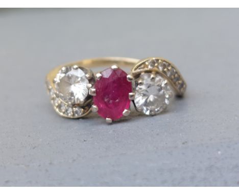 A three stone crossover set ruby &amp; diamond ring on '18ct shank.  Finger size M.