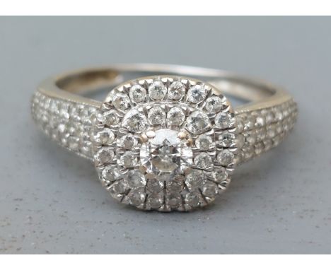 A modern diamond set white metal cluster ring.  Finger size R.