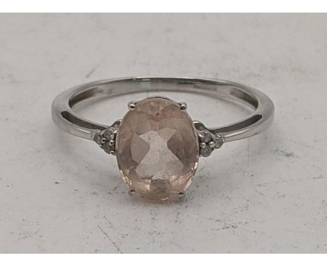 A 9ct white gold ring with a central oval Galieia morganite flanked by diamonds, size S 1/2, 2g, with a certificate of authen