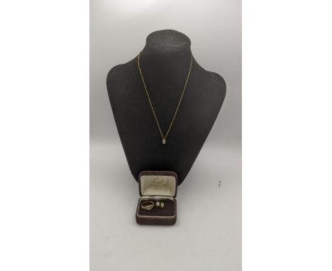 A Three piece 9ct gold and blue topaz suite to include a pair of earrings, necklace and pendant and ring total weight 2.5gLoc