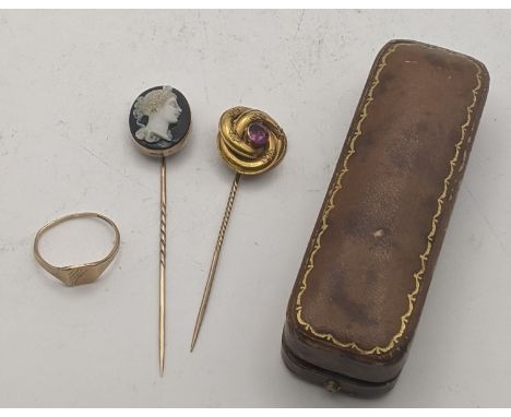 A yellow gold cameo stick pin, tested as 9ct gold, together with a Victorian yellow metal stick pin set with an amethyst colo