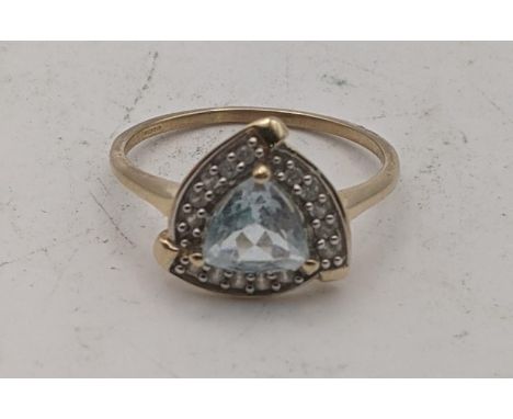 A 9ct gold ring set with a triangular Pedra Azul aquamarine and white zircon, size Q, 2.2g with a certificate of authenticity