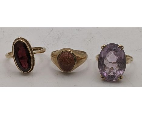 Three 9ct gold ladies rings to include a 9ct ring oval faceted cut garnet example along with two others total weight 11.3gLoc