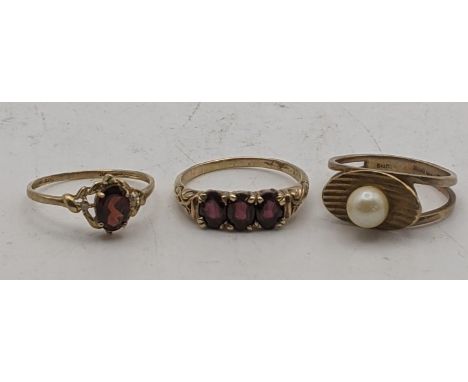 three 9ct gold ladies rings to include a gold and pearl ring, a three stone garnet example and one other total weight 7.3gLoc